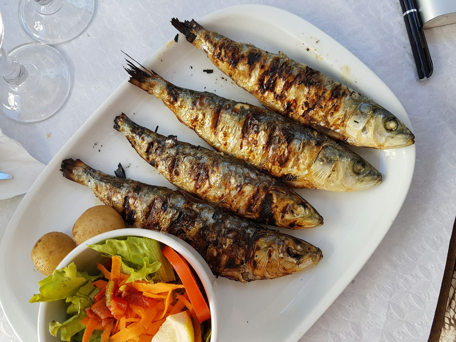 Whole grilled fish plated with a side salad — placeholder, swap with the restaurant's own shot